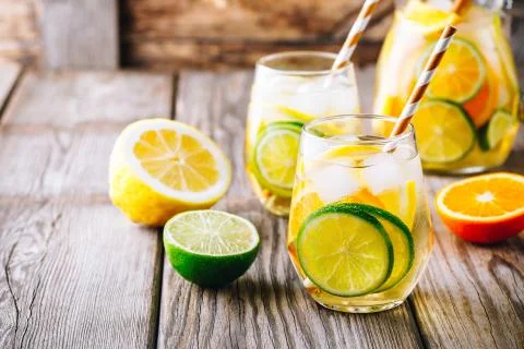 A refreshing summer ice-cold drink. White wine sangria in glass with lime, le Stock Photos