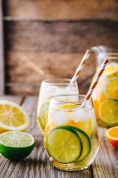 A refreshing summer ice-cold drink. White wine sangria in glass with lime, le Stock Photos