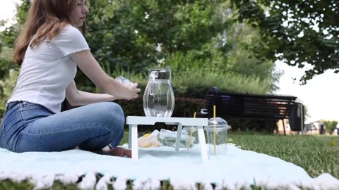 Refreshing summer picnic in the park with drinks and snacks Stock Footage 297370318