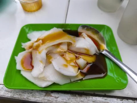 Refreshing Sweet Coconut Pudding Dessert with Syrups on Green Plate 写真素材