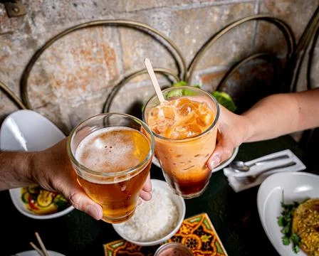 Refreshing Thai beverages held by hands Stock Photos