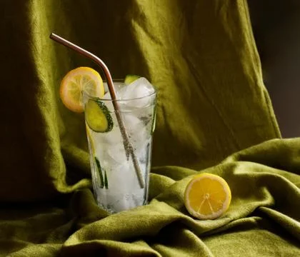 Refreshing tonic and gin Tom Collins cocktail or lemonade with lemon ice and  Stock Photos