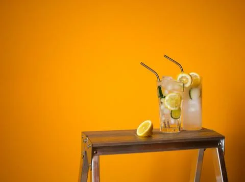 Refreshing tonic and gin Tom Collins cocktail or lemonade with lemon ice and  Stock Photos