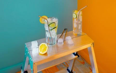 Refreshing tonic and gin Tom Collins cocktail or lemonade with lemon ice and  Stock Photos