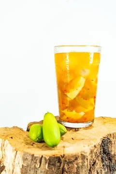 Refreshing tropical fruit pickle featuring sliced young mango, bilimbi, and l Stock Photos