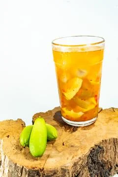 Refreshing tropical fruit pickle featuring sliced young mango, bilimbi, and l Stock Photos