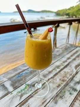 Refreshing Tropical Mango Drink on Rustic Table by the Bay Stock Photos