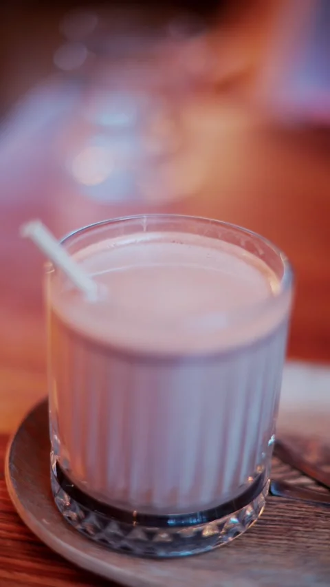 A refreshing vertical video of a drink in a beautiful clear glass with a st.. Stock Footage 339652755