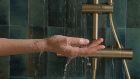 Refreshing Water Flowing Over Hand with Blurry Copper Tap Background Stock Footage 330822861