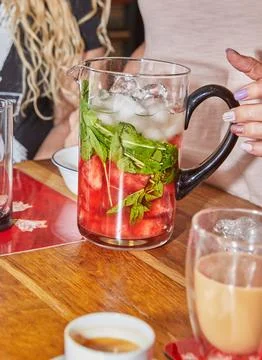 Refreshing Watermelon and Mint Drink in Pitcher with Ice and Glass Stock Photos