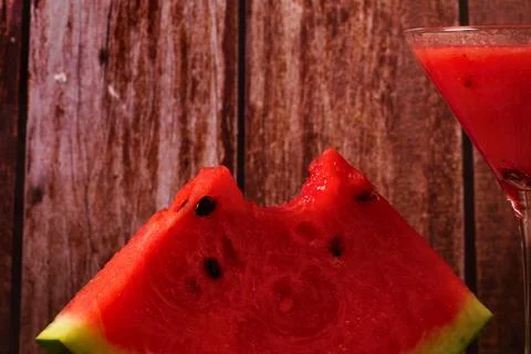 Refreshing watermelon slice and smoothie on rustic wood background Stock Photos