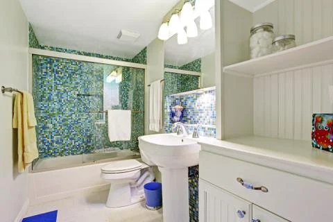Refreshing white bathroom with aqua tile wall trim Stock Photos