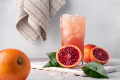 Refreshment iced drink. Red or blood Sicilian orange juice in a glass and fre Stock Photos