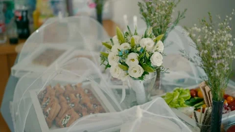 A refreshment table with a bouquet of white flowers. Stock Footage 226758166