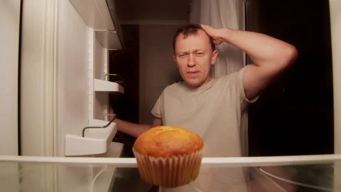 Refrigerator of a lonely young man, one spoiled cupcake on the shelf Stock Footage 144355580