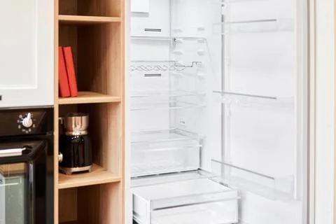 Refrigerator. Open door of an empty fridge. Household appliances in the store Stock Photos