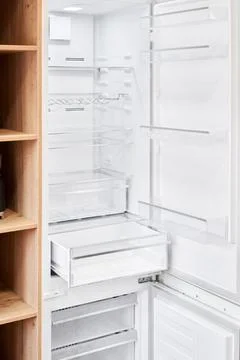 Refrigerator. Open door of an empty fridge. Household appliances in the store Stock Photos