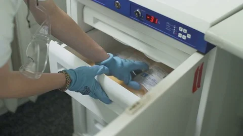 Refrigerator for storing packages with frozen plastic bag with blood plasma. Video stock 74287699