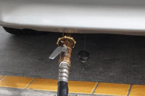 Refuel lpg by pump nozzle at cheap gas station Stock Photos