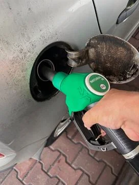 Refueling a car with Natural 95 E10 gasoline. Stock Photos