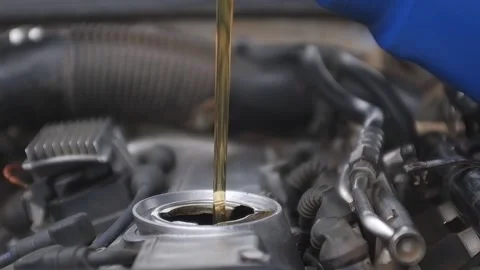 Refueling with fresh engine oil. Engine oil pours from the canister into the eng Stock Footage 165127520