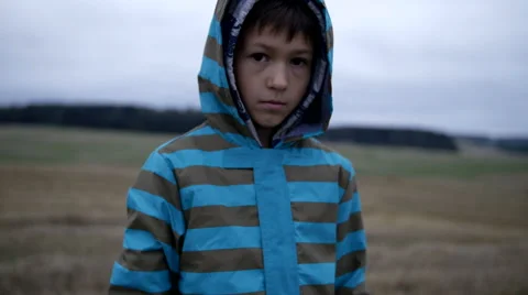 Refugee boy looks compassionately at the camera, homeless boy, pain on face Stock Footage 68450142