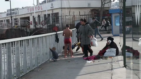 Refugee family while children dressing and mother talking to phone in Istanbul Stock Footage 149189132