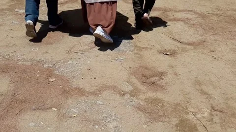 Refugee Legs Walking On Dry Arid Brown Soil Ground Drought Crisis Background Stock Footage 322049032