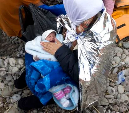 Refugee migrants, arrived on Lesvos in inflatable dinghy boats Stock Photos