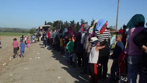 Refugees and migrants queue for food at refugee camp of Idomeni. Migrant crisis. Stock Footage