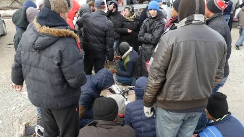 Refugees and migrants wait on the Greece-Macedonia border near Idomeni Stock-Footage 99181724