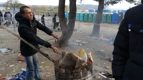 Refugees and migrants wait on the Greece-Macedonia border near Idomeni Stock-Footage 99181726