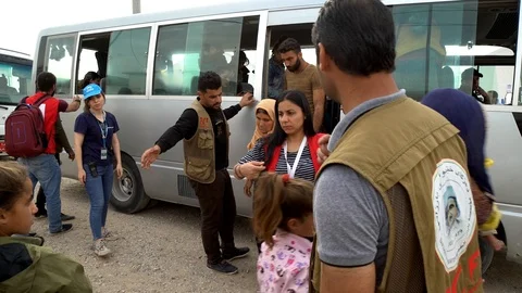 Refugees Unloading from Vans co Stock Footage 120932132