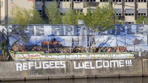 Refugees Welcome graffiti on wall, long shot, Berlin, Germany Stock Footage 70727449