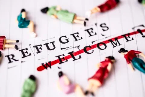 Refugees welcome strikethrough text on white line paper with face off woman f Stock Photos