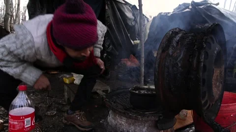 Refugess in jungle camp making fire Bosnia  Stock Footage 194970942