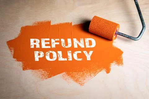 Refund Policy concept. Paint roller with orange paint on a wooden surface Stock Photos