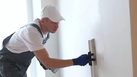 Refurbishment. Worker spackling a wall with putty 動画素材 85398401