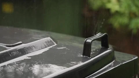 Refuse Bin being pelted with Rain During a Thunderstorm Stock Footage 280829343