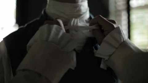 Regency-era man being dressed by another - formal dress, tying neck cloth Stock Footage 100477251
