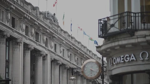 Regent St., flags, stunning grand facade, Omega Wall Clock, Omega Store Stock Footage 93329008