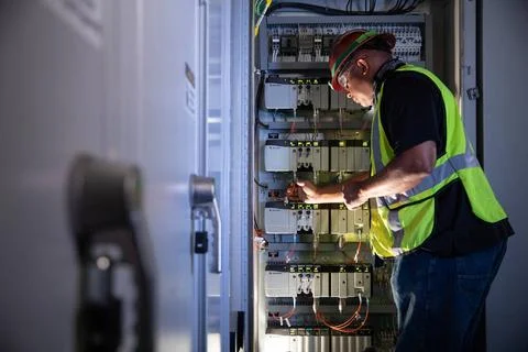 Reggie Martin, an engineer with Exploration Ground Systems, works on racks... Stock Photos
