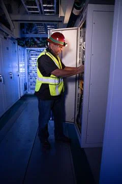 Reggie Martin, an engineer with Exploration Ground Systems, works on racks .. Stock Photos