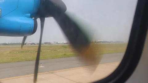 Regional Flight View from window shows propeller. This Regional Flight View Stock Footage 325779942