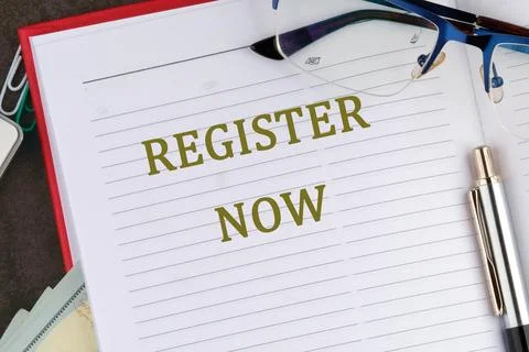 REGISTER NOW words written in the notebook of a businessman, a top manager, a Stock Photos