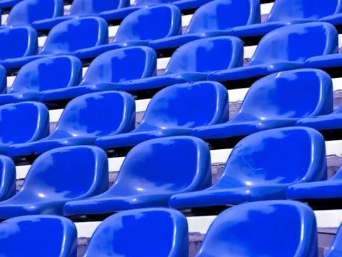 Regular blue seats in a stadium Stock Photos