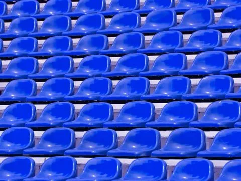Regular blue seats in a stadium Stock Photos