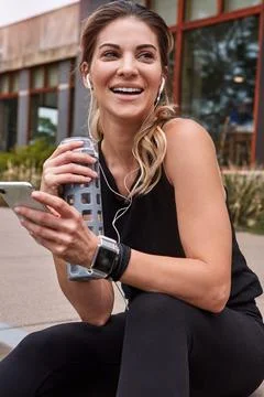 Regular exercise will make you a much happier person. a sporty young woman using Stock Photos