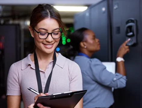 Regular maintenance is key. an attractive young female programmer working in a Stock Photos