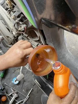 Regular maintenance of motor vehicles by changing the oil Stock Photos